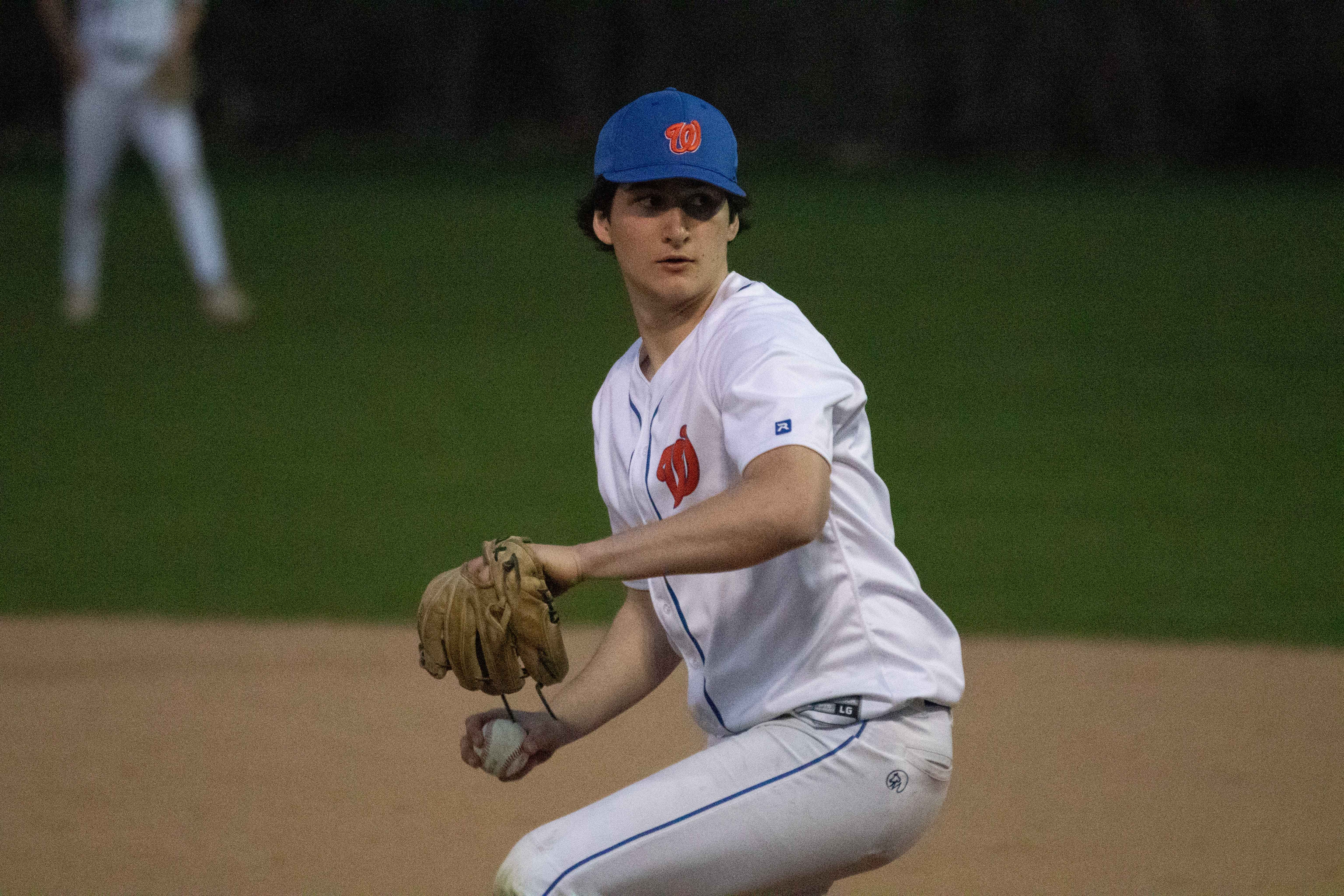 Washburn pitcher delivering pitch during night game